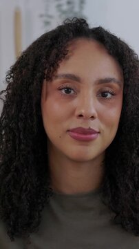 Vertical HD video. POV of African American businesswoman listening during a video call from home. Young professional attending online business meeting on laptop in a modern kitchen