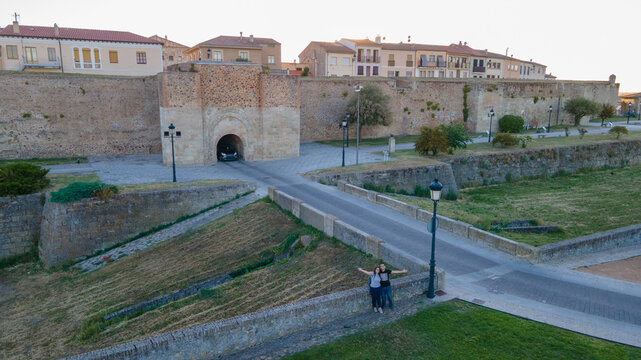Couple exploring ancient Ciudad Rodrigo city walls in Spain
