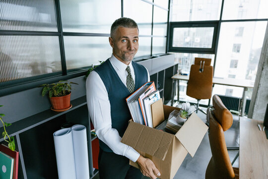 Fired and unemployment with business man. Job loss. Fired jobless employee. Unemployment crisis of man dismissed. Business man packing stuff. Unemployment crisis. Upset office worker is fired