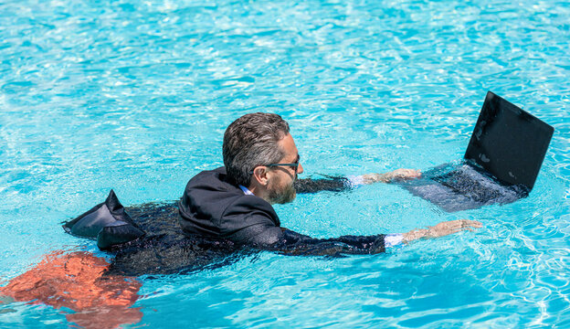 Summer business vacation. Crazy summer. Businessman rest in formal wear in pool. Businessman in suit with laptop in swimming pool. Crazy business man summer vacation. Remote working office