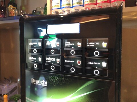 FLORENCE, ITALY - MAY 16, 2017: Digital coffee machine offering Italian drink selections. The photograph documents air travel and airport activity as seen on the stated date.