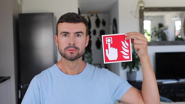 Man holding sign with hand pressing red button