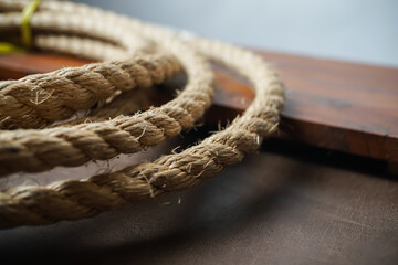 Coiled rope on rustic wood and leather © wdnld