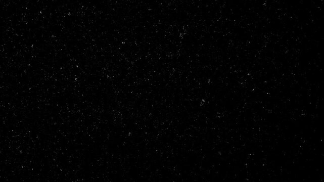 Black background texture. Seamlessly looping stop motion dark grunge texture with many small white specs animation.