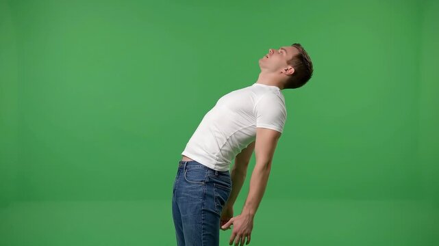 Man performing a backward bend against a green screen