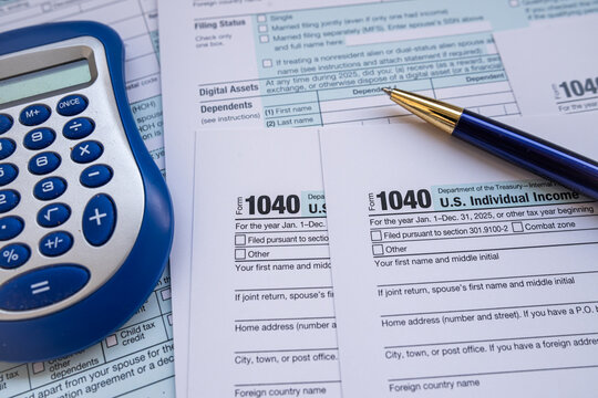 US Individual Income Tax Return Form 1040 with Calculator and Pen for Annual Tax Filing Concept