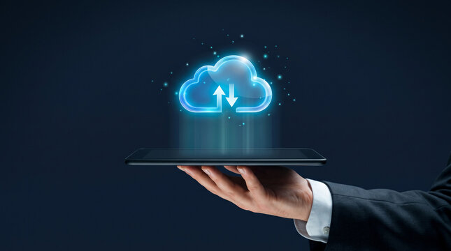 Hand holding tablet with glowing cloud computing data transfer icon on dark background
