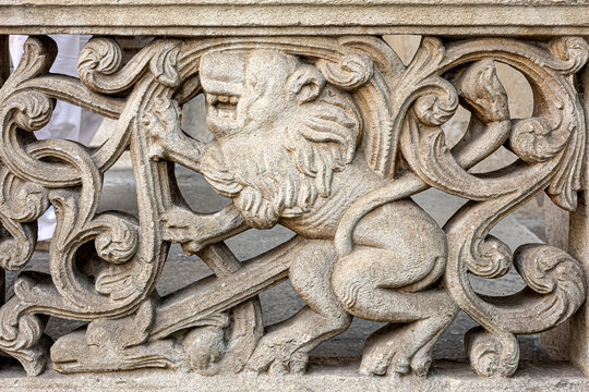 Stone carving of roaring lion in decorative architectural detail