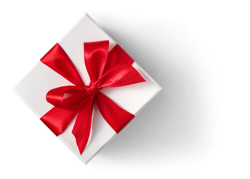 White gift box with red satin ribbon bow on white or transparent background