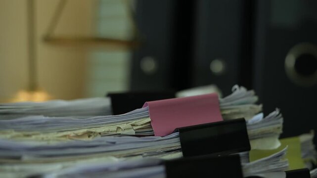Stacked Legal Case Files with Justice Scale in Professional Office