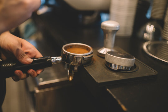 Preparing espresso with coffee tamper