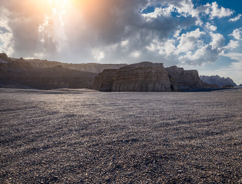 Wide-angle view of yardang landforms under dramatic white clouds and blue sky in Dahaidao, Gobi Desert, Xinjiang, China