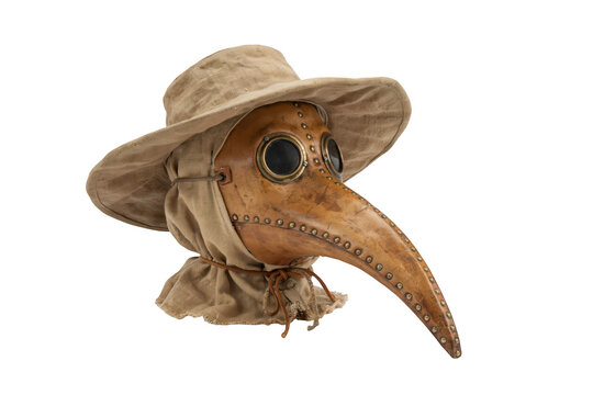 A classic leather plague doctor mask with a long beak, brass eye goggles, and a tan fabric hood with a wide brimmed hat, isolated on black background