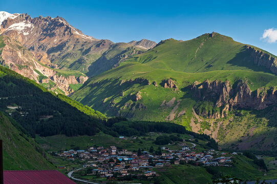 Panoramic Mountain Landscape with Snowy Peaks in a Scenic Alpine Landscape in Blue Sky, Scenic Natural Wilderness at Stepantsminda, Kazbegi city, Georgia. Mountain