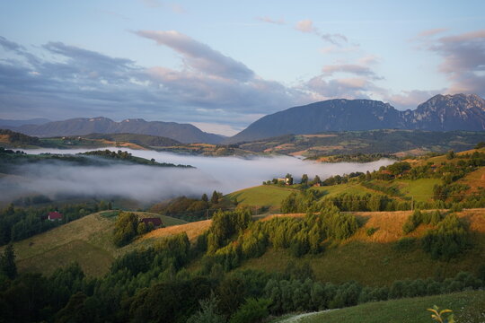 Sunrise Over Misty Hills and Meadows in Romania