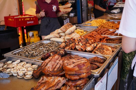 Street Food Grill with Pork Belly, Meat Skewers, Fish and Mici at a Romanian Street Festival
