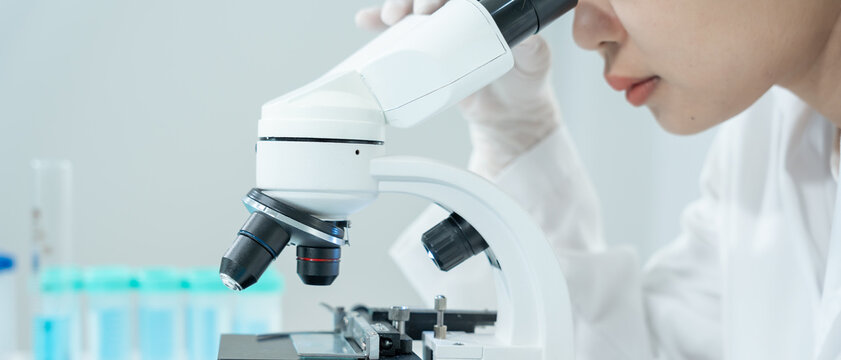 Scientist analyze biochemical samples in advanced scientific laboratory. Medical professional use microscope look microbiological developmental of viral. Biotechnology research in science lab.