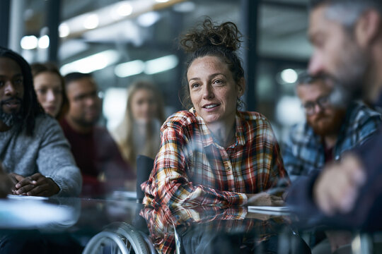 Businesswoman in Wheelchair Leading Meeting with Colleagues