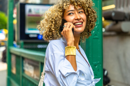 Young woman enjoying lifestyle while talking on phone in new york city