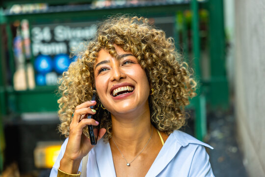 Happy woman talking on phone in new york city