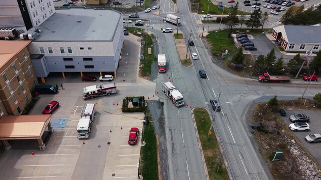 Aerial views capture the urgency in Halifax, Nova Scotia, as fire trucks respond to a hotel fire, evacuating guests who gather outside for safety