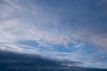 Fototapeta premium Clouds and blue sky during early evening at a coastal location