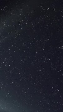 Animation of glowing white light over stars on night sky