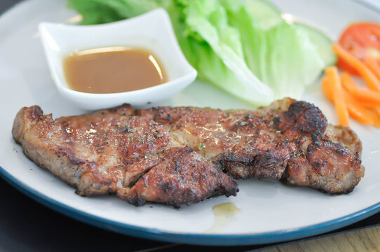 pork steak or grilled pork and salad or pork chop and vegetable
