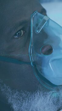 Animation of data processing over african american man using oxygen mask