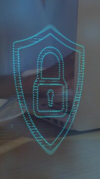Animation of lens flares and padlock in shield over midsection of businesswoman using laptop