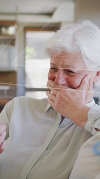 Animation of red pattern over caucasian female doctor in laboratory