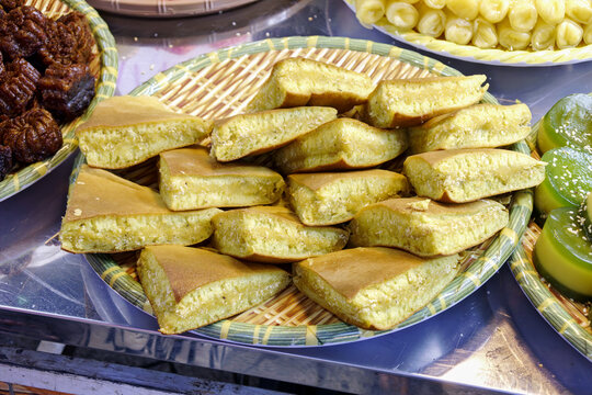 Apam Balik and Banh Kep Dau Phong peanut pancakes on tray showcasing Southeast Asian street food tradition.