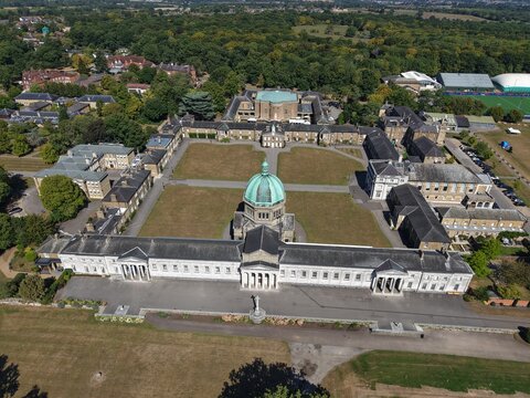 Hertford, England, United Kingdom - 17 August 2025: Aerial view of the historic Haileybury School campus with its iconic central dome, neoclassical architecture, green lawns, and trees.