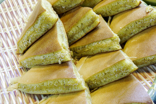 Delicious Apam Balik and Banh Kep peanut pancakes served in a woven basket, traditional Southeast Asian dessert.