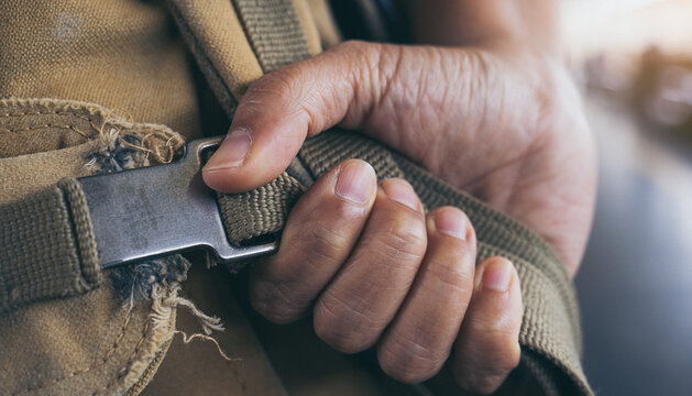 Close-Up of Hand Fastening Seatbelt in Vehicle