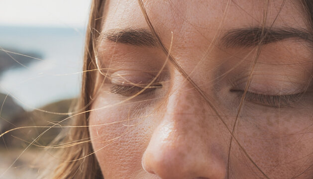 Close-Up of a Woman's Face with Eyes Closed in Nature