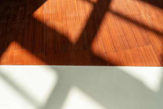 Abstract Sunlight and Shadows on Warm Wooden and White Interior Walls