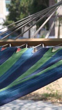 A cozy hammock suspended between two trees in a public park