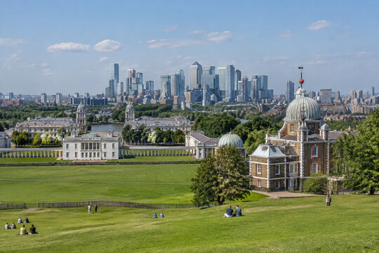 Green hill overlooking historic observatory and modern skyscrapers in distance.
