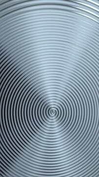 Rotating Metallic Spiral Texture. Macro view of silver metal rings spinning around the center in a hypnotic radial pattern.