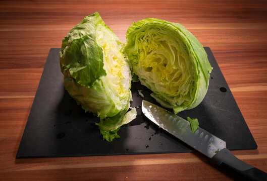 Fresh Iceberg Lettuce Cut in Half with Kitchen Knife