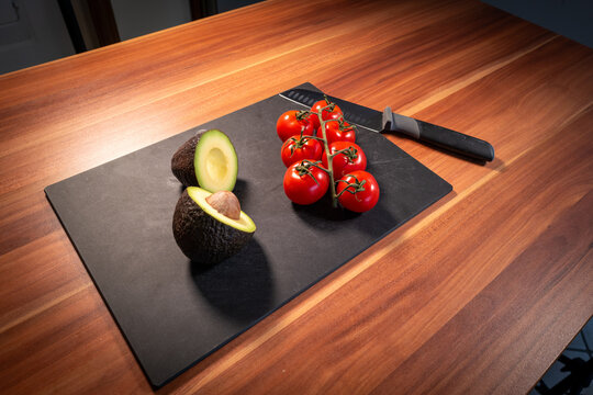 Avocado Halves and Tomato Vine on Kitchen Counter