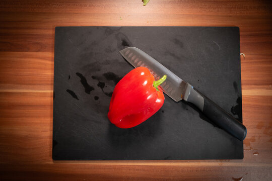 Fresh Red Bell Pepper Beside Knife in Home Kitchen