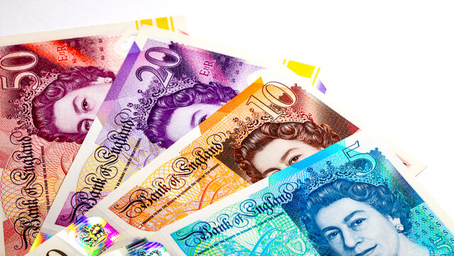 British currency, featuring various Great Britain Pound (GBP) banknotes including 5, 10, 20 and 50 pound notes with Queen Elizabeth II portrait. Money of Europe.