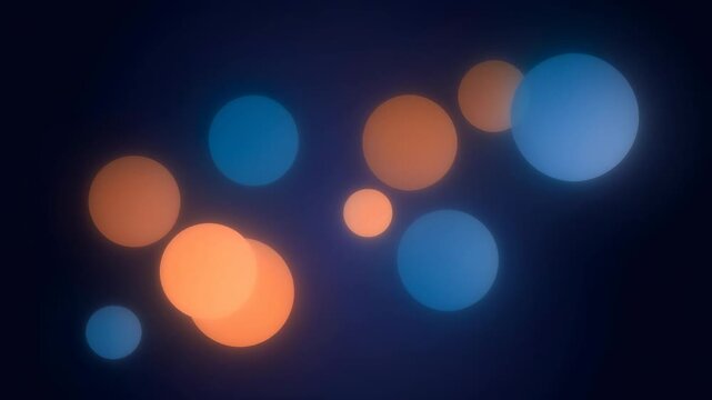 Abstract colorful bokeh lights glowing in blue and orange on dark background for festive and creative design