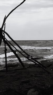 A black and white  of a teepee on the beach, great for travel or outdoor lifestyle scenes