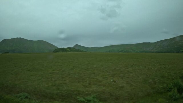 Driving past flat green plains and peat bog in Andoya Norway