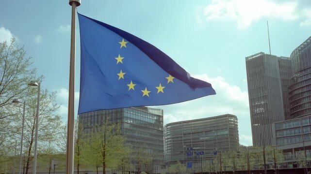 European Union Flag Waving in Front of City Buildings