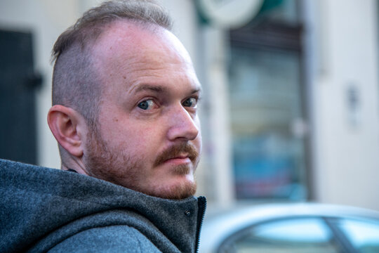 Close Up Portrait of Man Looking Back on City Street in Bucharest