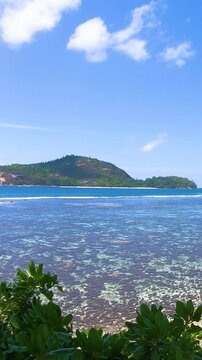 Vertical panoramic view of the coral reef at Port Glaud in Seychelles with turquoise water, tropical coastline and spectacular Indian Ocean scenery.